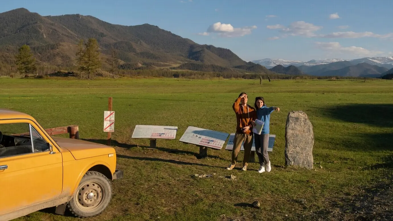 Distant view of people outdoors with a map