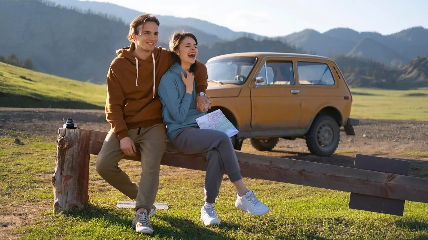 Full shot of people sitting outdoors.